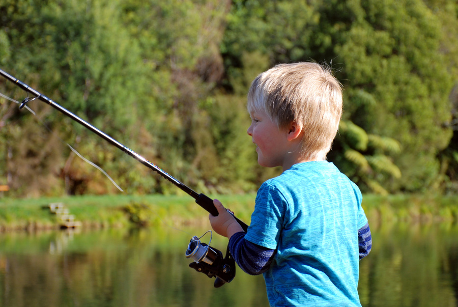 Young Child Fishing at River