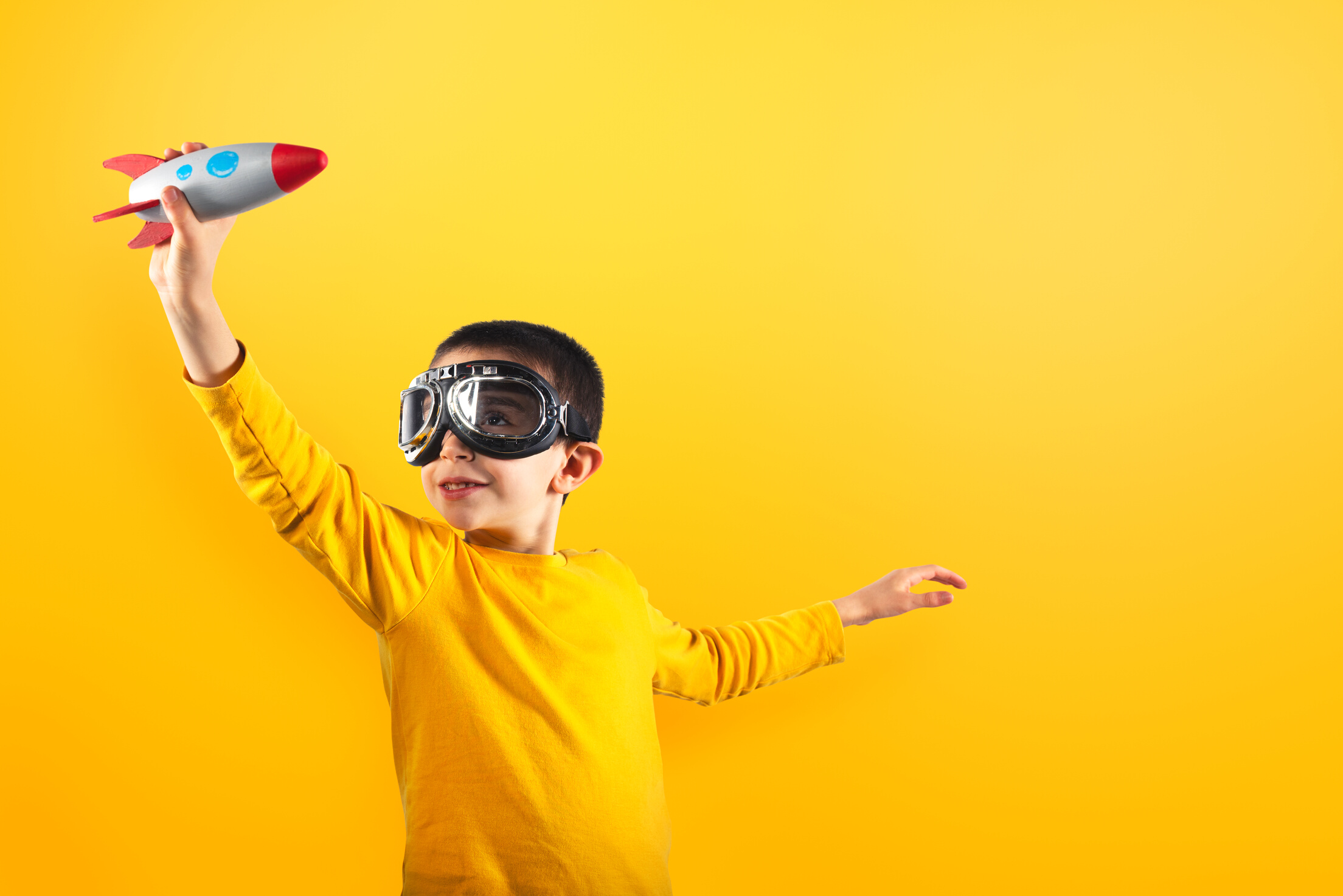 Child Plays with a Rocket. Concept of Imagination.